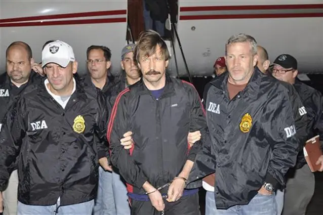 Viktor Bout, being escorted by DEA agents